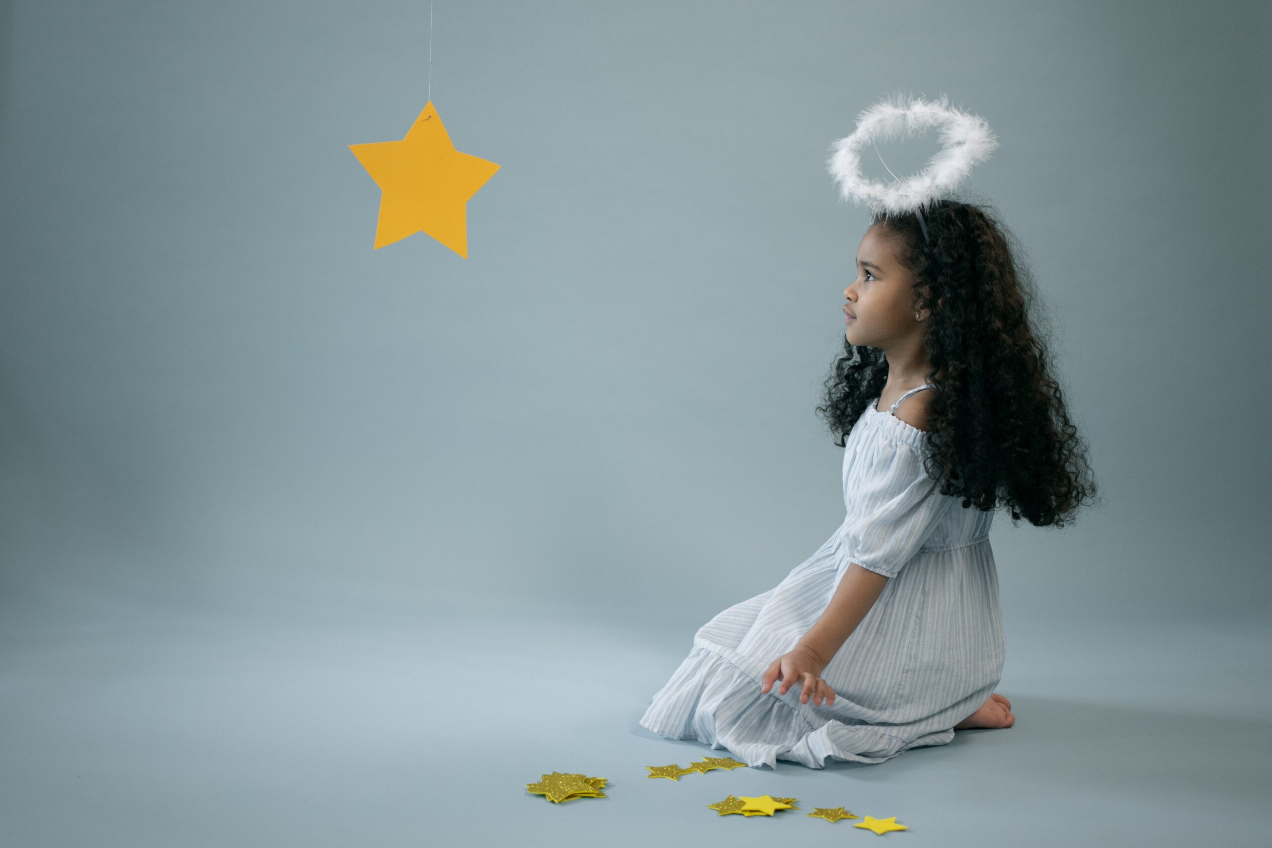a girl wearing a paper star