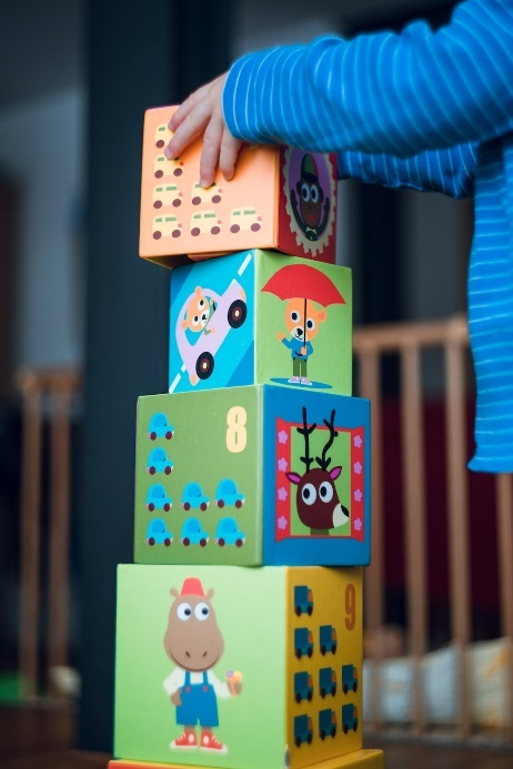 A child playing with cartoon-themed blocks.