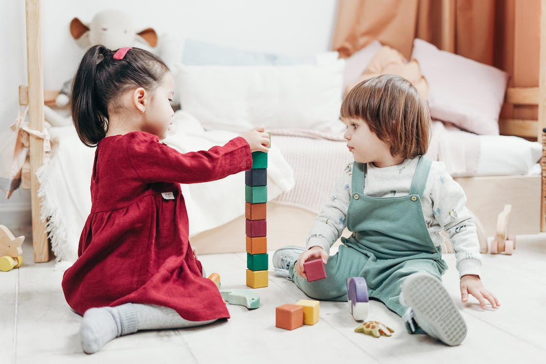 Toddlers playing with blocks.